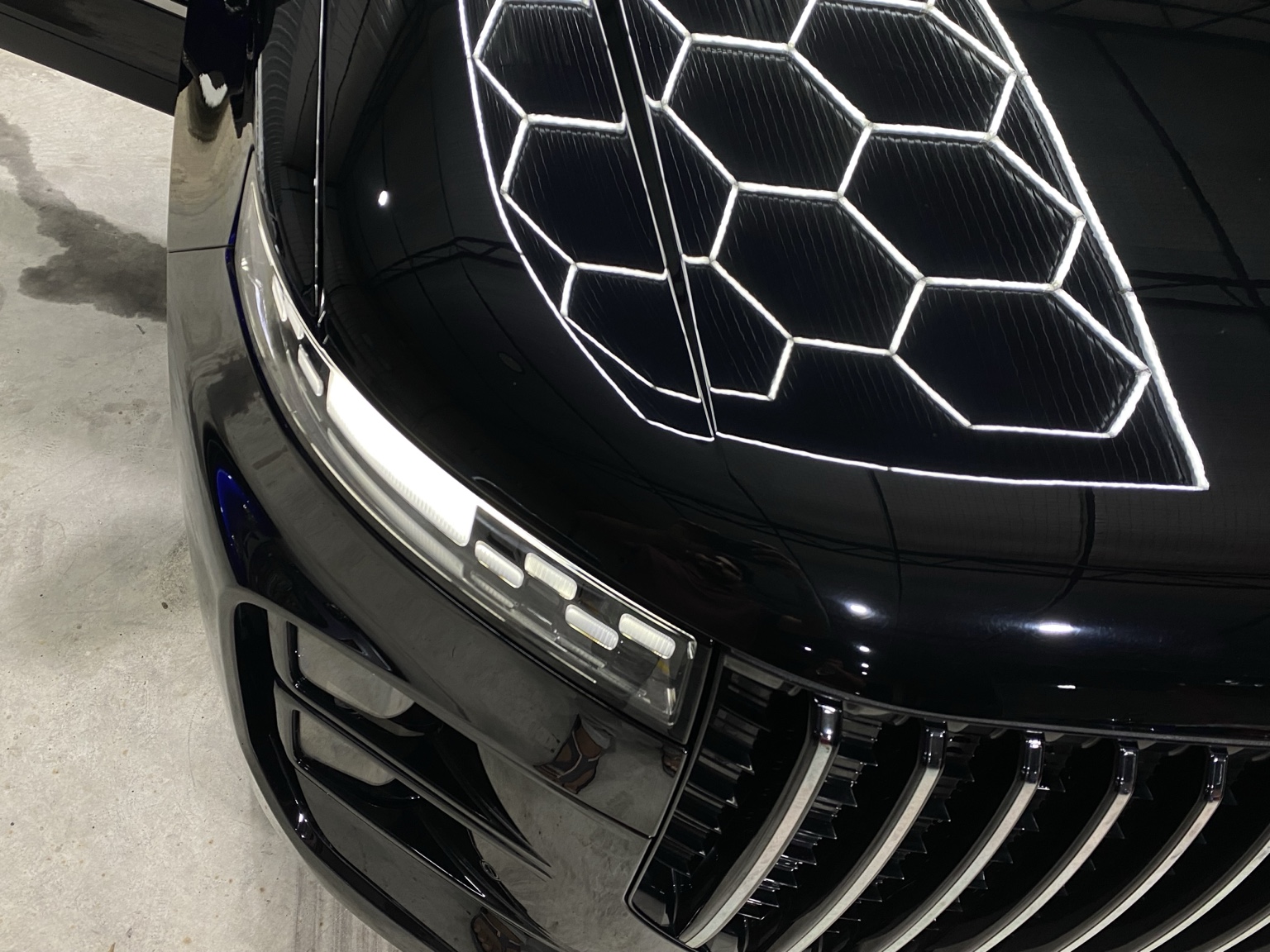 High gloss close-up on black vehicle hood
